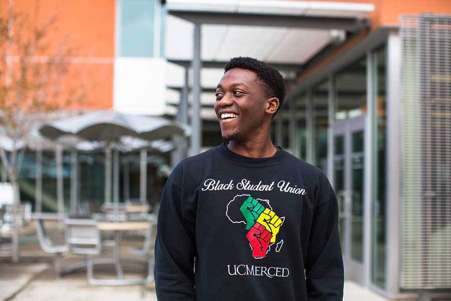 Young black man wearing a Black Student Union shirt at UC Merced