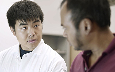 Student Alex Li, left, works with Professor Anand Subramaniam, right, on a portable machine to diagnose diseases.