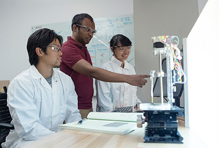 CSU Stanislaus student Will Cheung, left, and UC Merced graduate student Melissa Xu, right, continue the diagnostic project with Subramaniam, center.