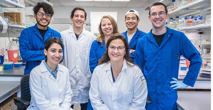 Bioengineering professor Eva de Alba in her lab with her students and postdoctoral scholar. Students in back row: Pedro Diaz-Parga, Arturo Gonzalez, Suzanne Sandin, Kevin Ramirez and Christopher Randolph. Front Row: Meenakshi Sharma and Eva de Alba.