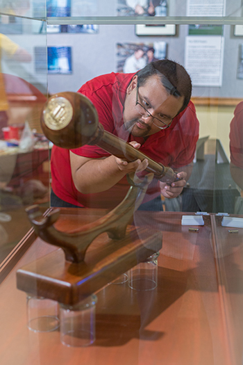 Ramon Barragan helps put the finishing touches on the UC Merced exhibit.