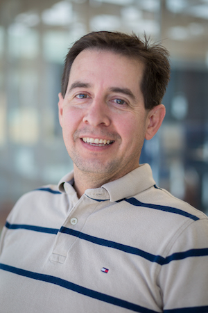 A man in a white and blue striped shirt.