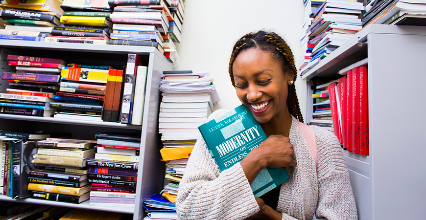 UC Merced student with books.